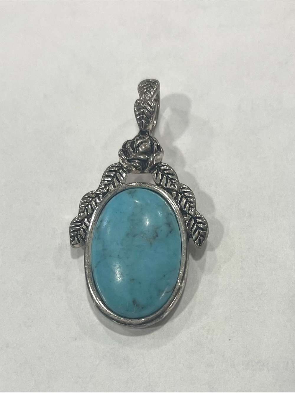 Turquoise Oval Silver Pendant with Leaf Accents